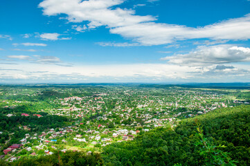 top view of the mountains and the village at the foot of the mountain, beautiful summer landscape. High quality photo