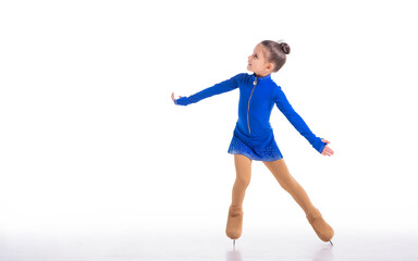A Little young figure skater posing in blue training dress on ice on white background