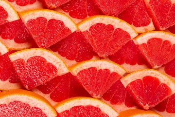 Grapefruit red juicy slices background. top view.