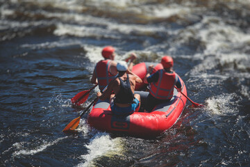 Raft boat during whitewater rafting extreme water sports on water rapids, kayaking and canoeing on the river, water sports team with a big splash of water