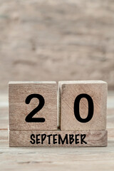 cube calendar for september on wooden background with copy space