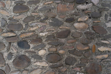 Texture of stone wall pattern background.Old european medieval floor street cobblestone pavement