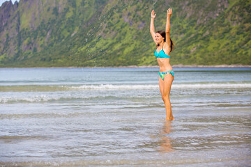 Woman, enjoying Ersfjord Beach on Senja island, beautiful landscape view over the mountains