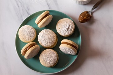 Delicious alfajores on a green plate