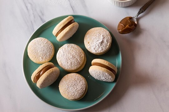 Delicious alfajores on a green plate