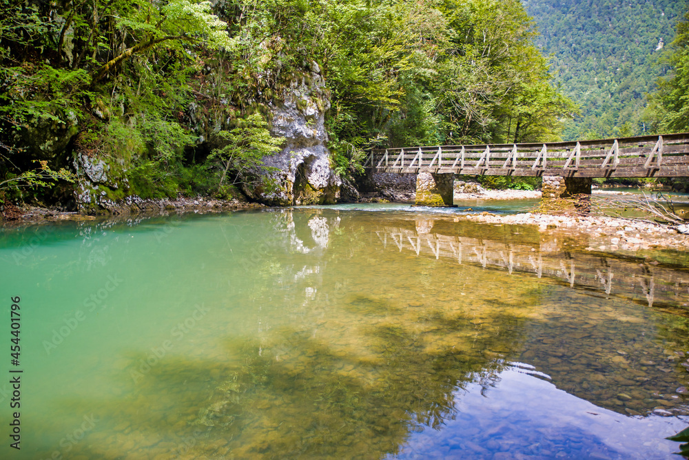 Wall mural a wooden bridge over the river kupa in risnjak national park