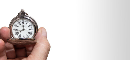 Man's hand holding a vintage pocket watch. Concept of time and work. Copy space. Isolated on white background. Selective focus.