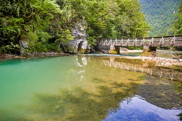 Selbstklebende Fototapeten a wooden bridge over the river kupa in risnjak national park © mschauer