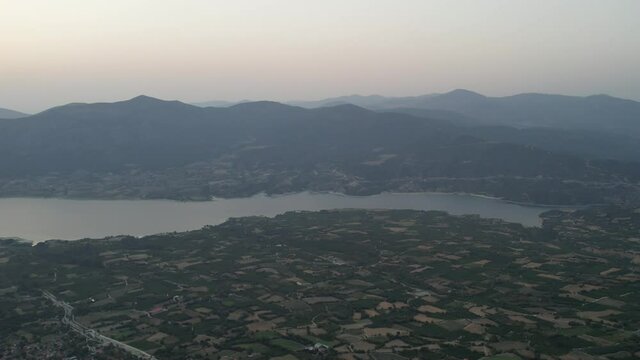 Aerial drone view over sunset Polyphytos Artificial Lake, Larissa, Greece.