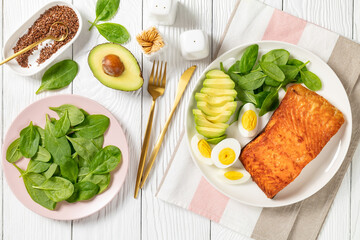 baked salmon fillet with eggs , spinach, avocado