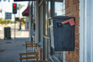 Mail box on the side of a building.