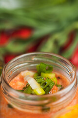 Selective focus on a glass jar with sauce for meat skewers