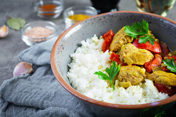 Spicy chicken curry with rice. Curry sauce with chicken and rice on gray background