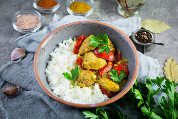Spicy chicken curry with rice. Curry sauce with chicken and rice on gray background