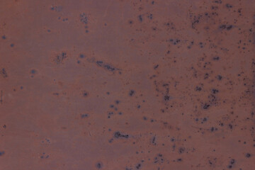 Old dark red rough metal wall with spotted of rusty