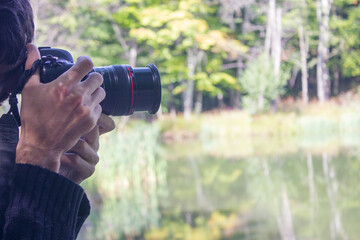 the photographer takes pictures by the lake