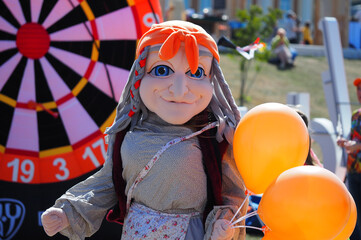 Life-size dolls, fairy-tale characters on a city holiday.