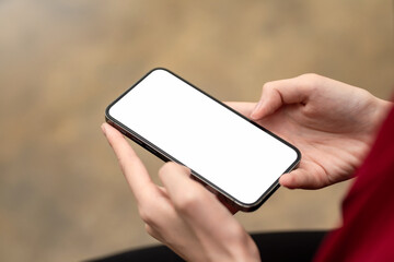 Image of a businesswoman working with a smartphone blank white screen at the office. Mock up.