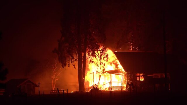 2021 - A house is engulfed in flames at night during the disastrous Dixie Fire in Northern California.