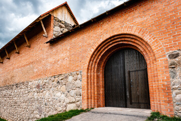 Fototapeta na wymiar Wooden door in the castle of red bricks.