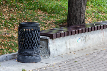 decorative cast iron black rubbish bin in the park. Vintage trashcan