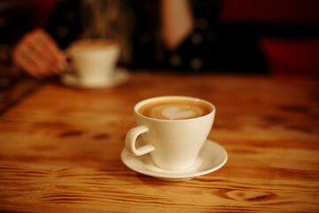 cup of coffee on wooden table