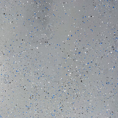 A freshly painted with a gray epoxy finish sprinkled with blue, black and white plastic chips.