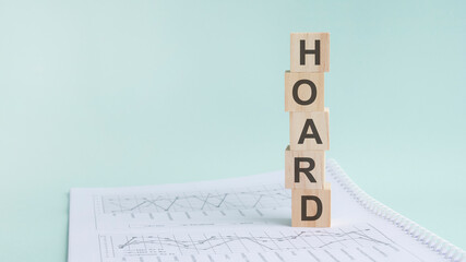 word HOARD with wood building blocks, light green background