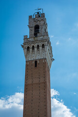 Fototapeta premium A photo of top part of Tower of Mangia, Siena, Italy