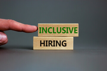 Inclusive hiring symbol. Wooden blocks with words Inclusive hiring on beautiful grey background....