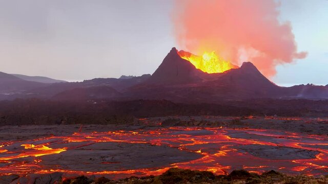 Amazing ground level shot of Iceland Fagradalsfjall volcano eruption with molten lava fields in motion foreground.