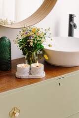 Two burning candles in interior. Relax in bathroom. Natural