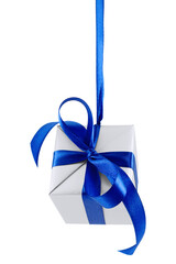 Hanging on a ribbon silver gift wrapped present with blue satin bow isolated on white