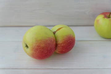 Close up image of two apples grown together, unusual shape, ugly food concept