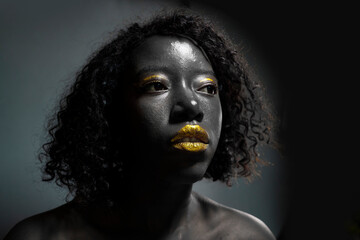 portrait of beautiful african woman with creative gold make up