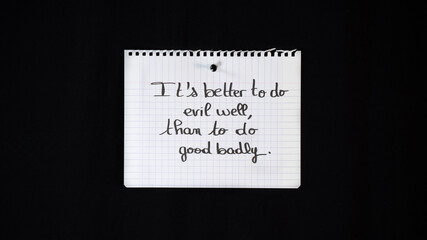 Hand written message on a ripped notebook sheet: better to do evil well, that to do good badly	