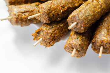 Minced and shaped lamb kebabs with chilli and coriander prepared for grill