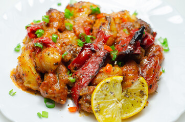 Tuscan style sauce with gnocchi, pork and beef meatballs and grilled red peppers garnished with fresh parsley and chive