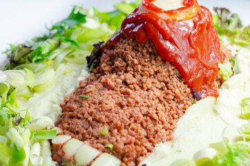 Minced meat formed in the shape of a foot, topped with a tomato sauce, a creative way of serving food for Halloween