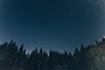 the night sky is covered with stars in the high mountains