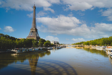 Fototapeta na wymiar Eiffel Tower and Alexandre III Bridge with reflection on Seine river in Paris, France