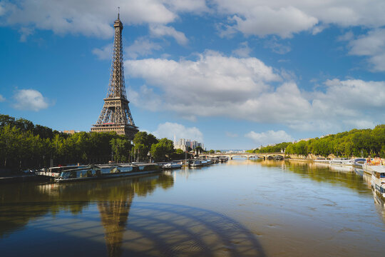 Eiffel Tower and Alexandre III Bridge with reflection on Seine river in Paris, France