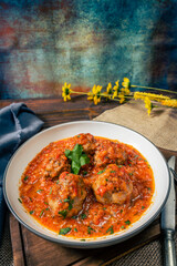 Meat balls or meatloaf with tomato sauce in a round dish. high view