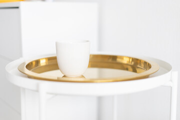 white mug on a white and gold table, minimalism
