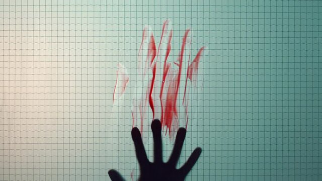 hand smearing blood on window brutal murder mysterious death concept
