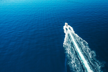 Aerial view of motor boat sailing in the sea. Amazing seascape with the fishing boat. 