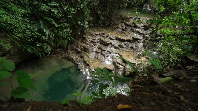 2021 - Excellent aerial shot of small waterfalls in the Chiapas rainforest of Mexico, surrounded by greenery.