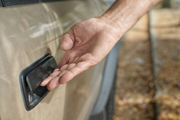 Opening up the door to a car.