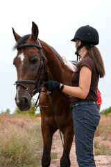 Obraz premium Portrait of a rider and her skewbald horse with a walk in nature