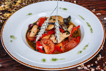 Fried chicken with fried tomatoes in sauce